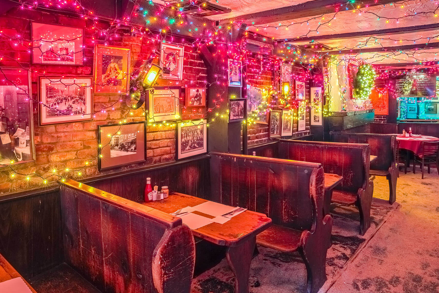 framed photos on a brick wall